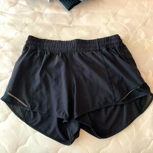 Lululemon women’s black shorts with liner and black mesh on outside leg.